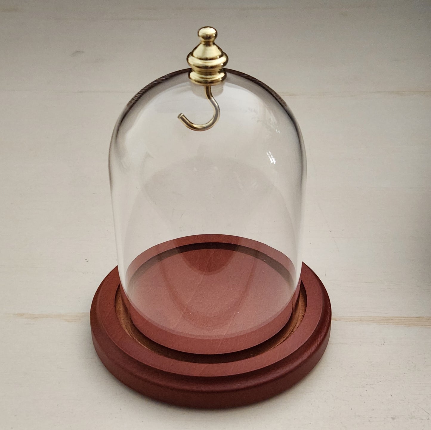 Pocket watch glass display dome cloche gold knob and hook walnut stained base 3"x4", front view.